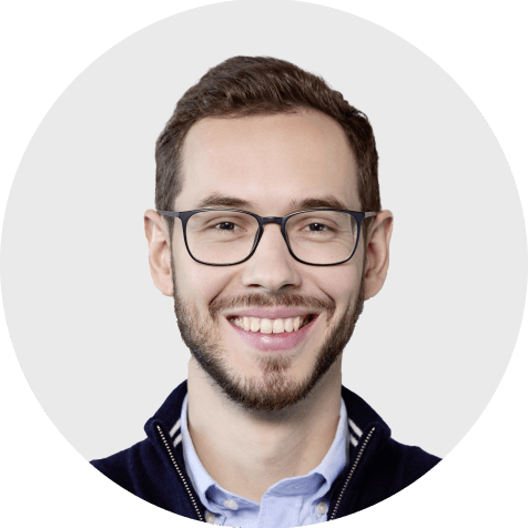 Henadez Kavaliou, lächelnd und mit Brille, Experte bei Scompler, präsentiert sich professionell.