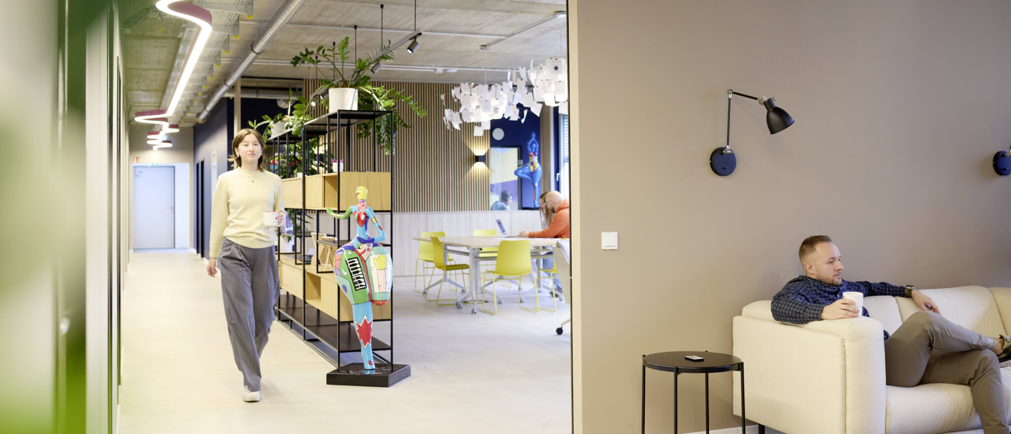 Dynamic modern office design: coworking space with relaxing lounge areas and creative art.